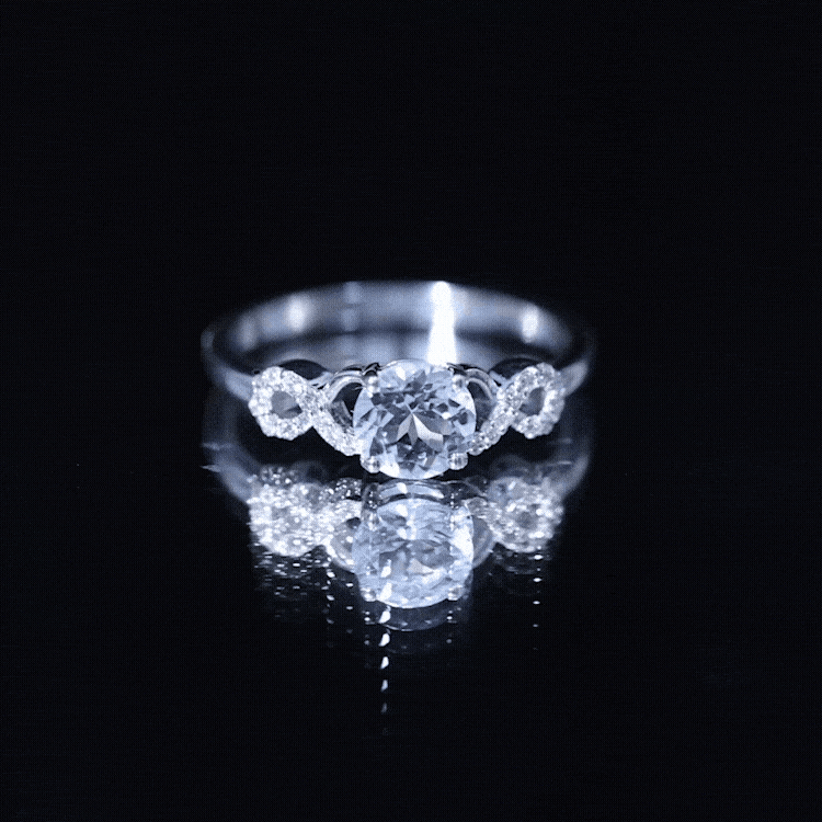 Round aquamarine and diamond infinity engagement ring by Rosec Jewels, featuring a yellow gold band and intricate design.