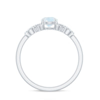 Natural moonstone solitaire ring with criss-cross diamond accents, featuring a 3/4 carat moonstone set in a rose gold band.