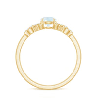 3/4 carat natural moonstone solitaire ring with criss cross diamond accents, featuring a rose gold band and intricate design.