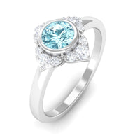 Bezel set aquamarine and diamond flower engagement ring by Rosec Jewels featuring a central aquamarine gemstone and surrounding diamonds.