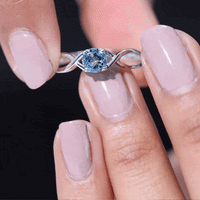 Solitaire aquamarine infinity promise ring by Rosec Jewels featuring a central aquamarine gemstone on a delicate band