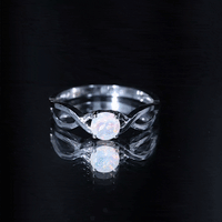 Natural Ethiopian Rainbow Opal promise ring with crossover shank from Rosec Jewels, showcasing vibrant rainbow-colored opal gemstone.