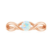 Natural Ethiopian rainbow opal promise ring with crossover shank, crafted by Rosec Jewels, showcasing vibrant color and elegant design.