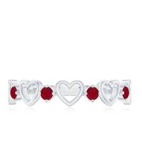 Natural ruby heart eternity ring by Rosec Jewels featuring a continuous row of heart-shaped rubies in a sleek silver band.