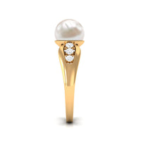 Freshwater pearl solitaire ring with diamond side stones by Rosec Jewels, showcasing a elegant pearl centerpiece and sparkling accents.