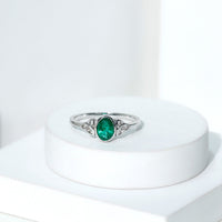 Oval Shaped Emerald Celtic Engagement Ring in Bezel Setting