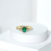 Oval Shaped Emerald Celtic Engagement Ring in Bezel Setting