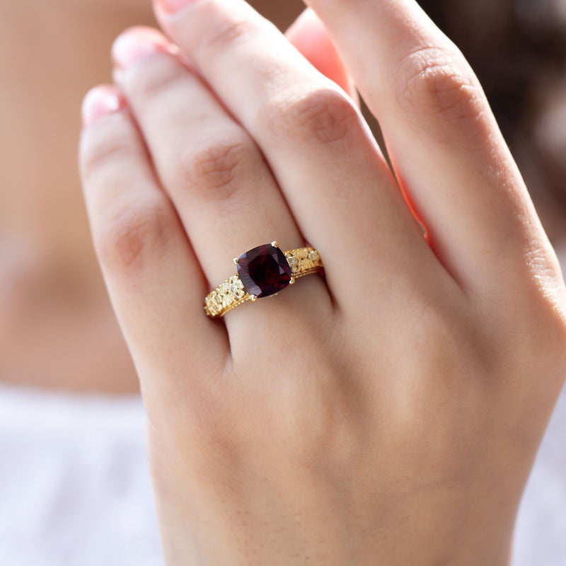 Rosec Jewels garnet engagement ring featuring a 3.2 carat cushion cut gemstone with diamond accents.