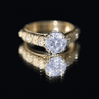 Yellow gold vintage engagement ring with a 2-carat moissanite gemstone in a double prong setting by Rosec Jewels.