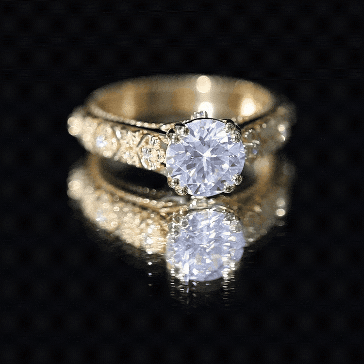 Yellow gold vintage engagement ring with a 2-carat moissanite gemstone in a double prong setting by Rosec Jewels.