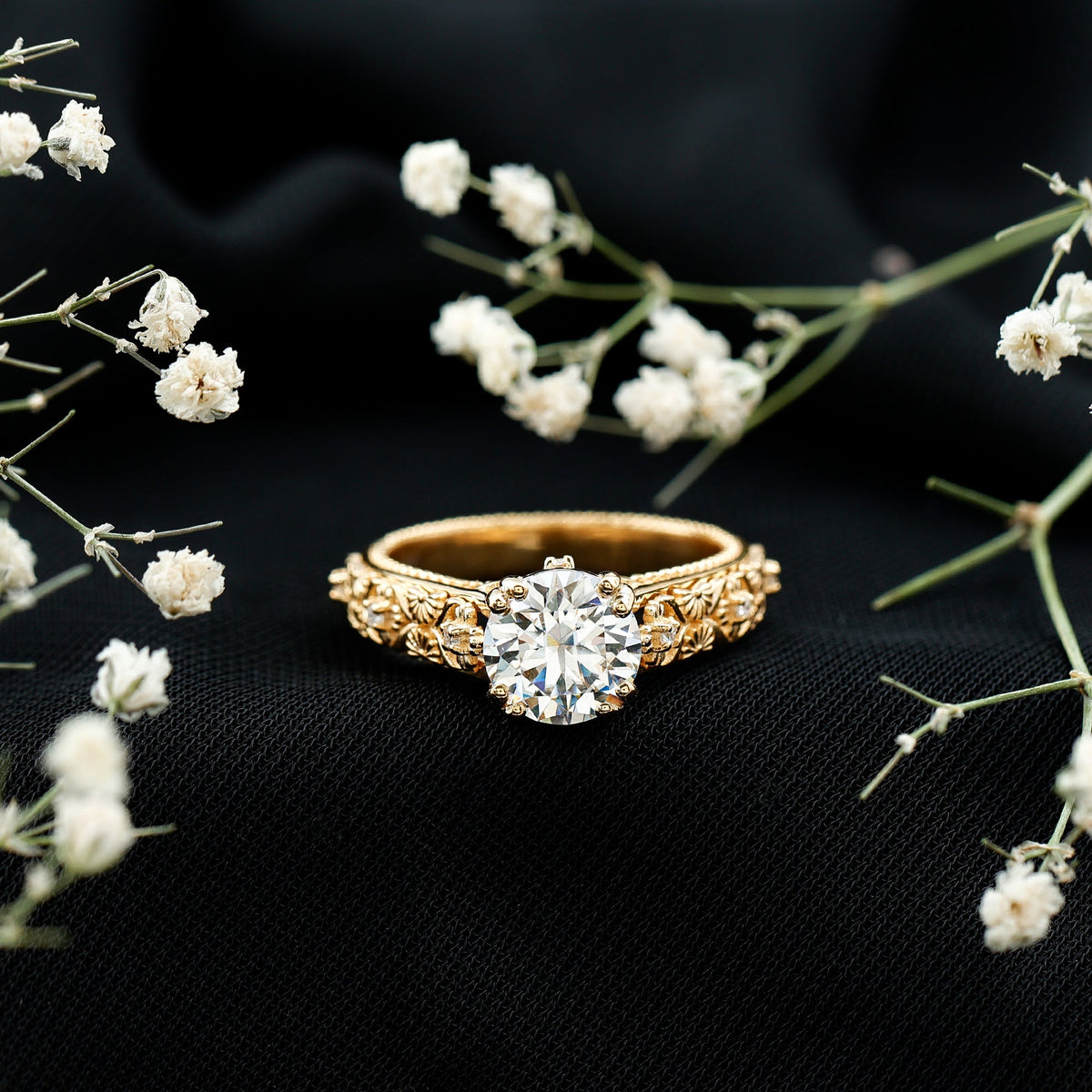 Two-carat moissanite vintage engagement ring with double prong setting from Rosec Jewels, featuring intricate metalwork and a sparkling central stone.