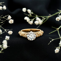 Two-carat moissanite vintage engagement ring with double prong setting from Rosec Jewels, featuring intricate metalwork and a sparkling central stone.