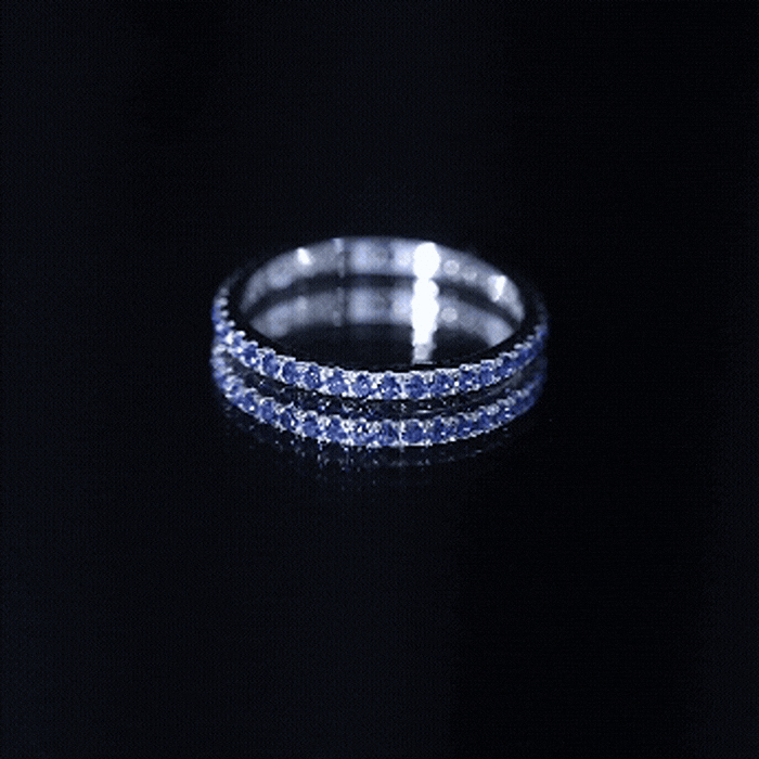 Lab grown blue sapphire eternity ring for women by Rosec Jewels, featuring a continuous band of sparkling blue sapphires.