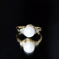 Natural 7.4 Carat freshwater pearl engagement ring with diamond trio by Rosec Jewels, featuring a yellow band and elegant design.