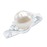 Natural 7.4 carat freshwater pearl engagement ring with diamond trio by Rosec Jewels, showcasing a elegant pearl centerpiece and sparkling diamonds.