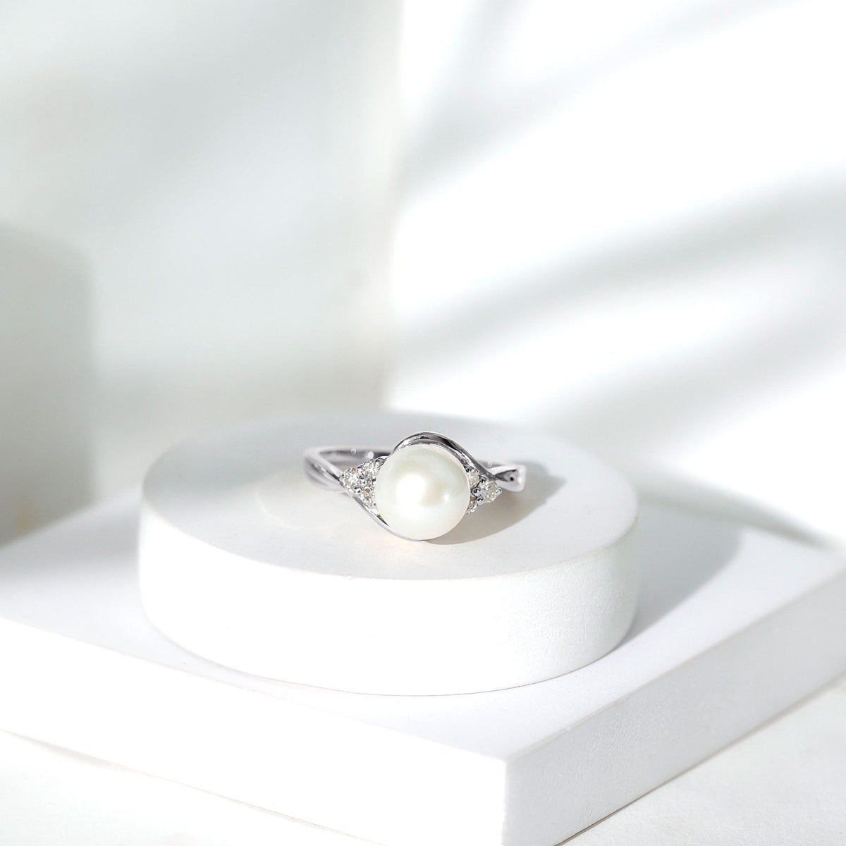 Natural 7.4 carat freshwater pearl engagement ring with diamond trio set in a Rosec Jewels ring, featuring elegant craftsmanship.