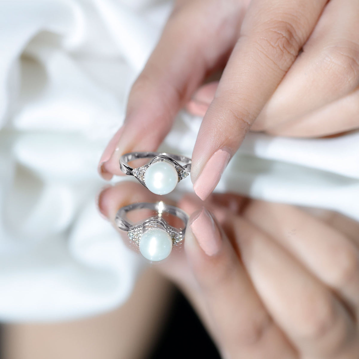 Natural 7.4 carat freshwater pearl engagement ring with diamond trio setting from Rosec Jewels, showcasing elegant ring design.