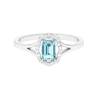 Emerald cut aquamarine engagement ring with diamond floral halo and rose gold band from Rosec Jewels.