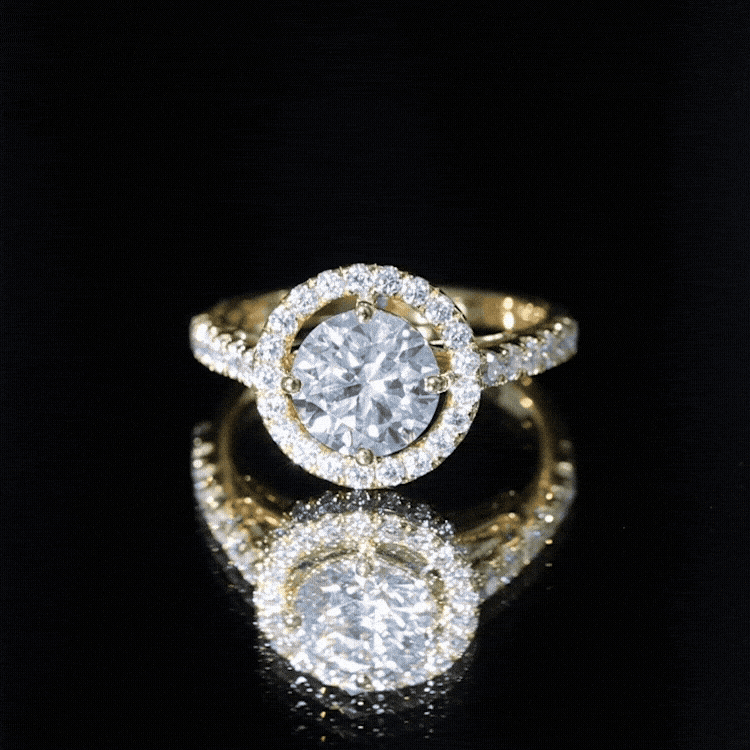 Yellow gold moissanite engagement ring with a 2-carat center stone and halo setting, showcasing intricate ring design.