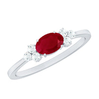 East West style 0.6 carat ruby oval promise ring with diamond accents by Rosec Jewels, showcasing a sleek gold band and vibrant gemstone.