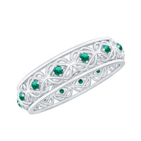 Vintage-looking lab-grown emerald wedding band for women, Rosec Jewels, featuring a detailed ring design with a central emerald.