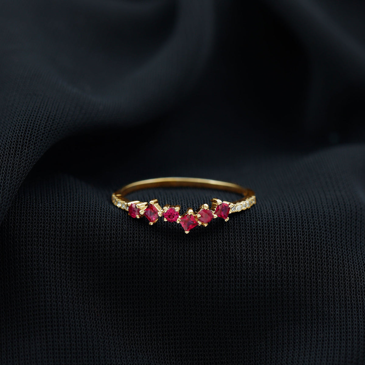 Lab grown ruby and diamond half eternity ring by Rosec Jewels, featuring a band with alternating gemstones and intricate metalwork.