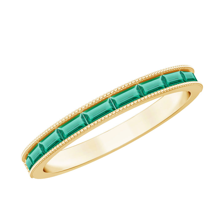 Lab-grown emerald eternity ring with beaded detailing by Rosec Jewels, featuring a baguette cut emerald band in a close-up view.