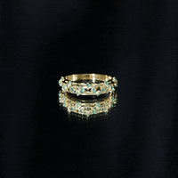 Natural emerald filigree wedding band for women featuring intricate gold detailing in a delicate ring design.