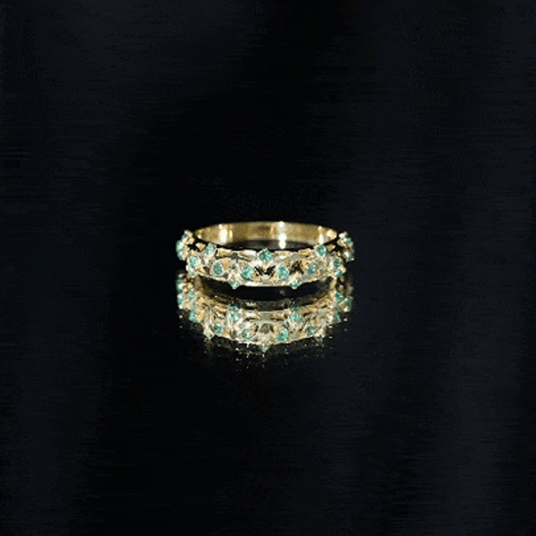 Natural emerald filigree wedding band for women featuring intricate gold detailing in a delicate ring design.