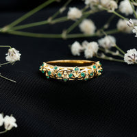 Natural emerald filigree wedding band for women, crafted by Rosec Jewels, featuring intricate gold filigree design and vibrant green emeralds.