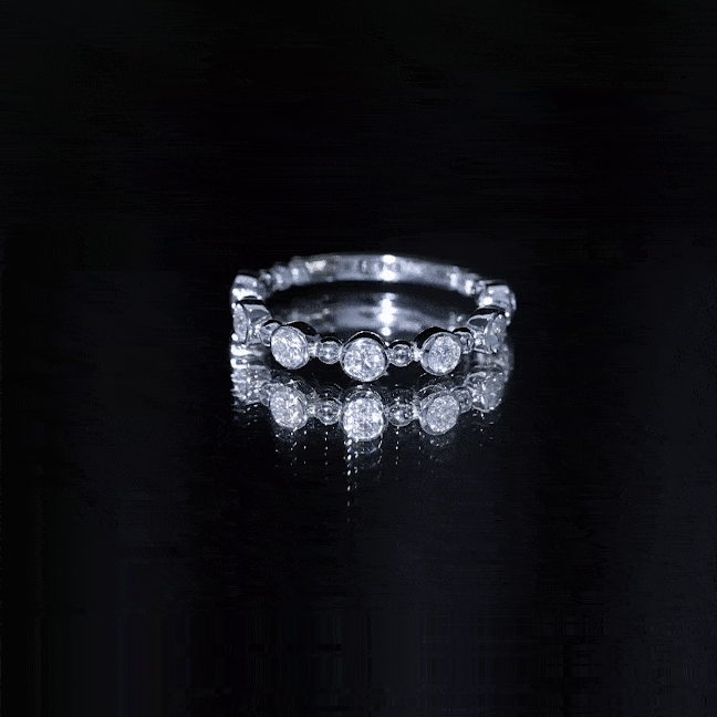 Yellow gold bezel set moissanite stackable anniversary band ring from Rosec Jewels featuring sparkling gemstone accents.