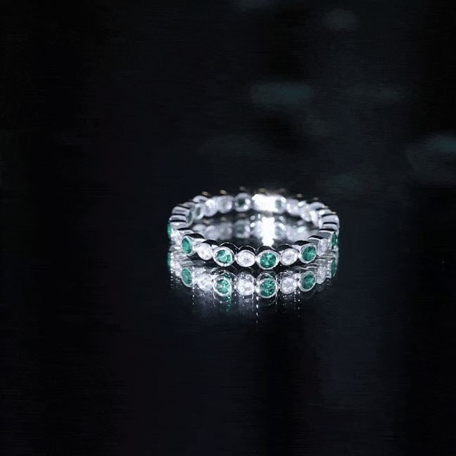 Alternating set lab emerald and moissanite full eternity ring by Rosec Jewels featuring green emeralds and sparkling moissanite stones.