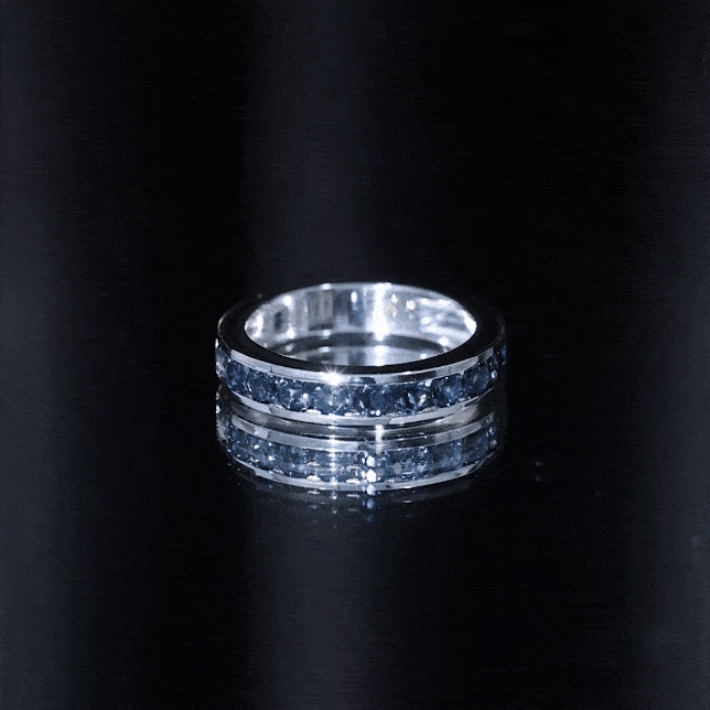 Rosec Jewels London Blue Topaz eternity ring with channel-set topaz stones in a sleek band design