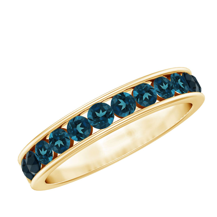Rosec Jewels London Blue Topaz channel set eternity ring with sparkling blue gemstones and polished silver band.