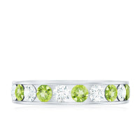 Channel set peridot and diamond half eternity ring for women by Rosec Jewels, featuring vibrant green peridot and sparkling diamonds.