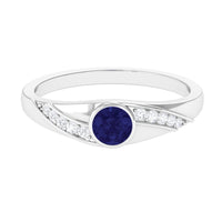 Bezel set blue sapphire and diamond men's engagement ring by Rosec Jewels, featuring a sleek band with gemstone accents.