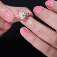 Elegant moissanite teardrop engagement ring with a scalloped shank, featuring sparkling white stones from Rosec Jewels.