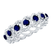 Natural blue sapphire infinity ring by Rosec Jewels featuring a band with blue sapphires and infinity symbol design.