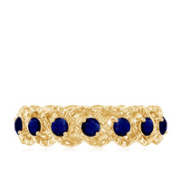 Elegant blue sapphire infinity band ring by Rosec Jewels featuring a continuous row of shimmering blue sapphires.