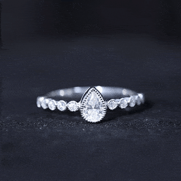 Pear-shaped lab grown diamond engagement ring with side stones in yellow gold, featuring a 5x7 mm diamond from Rosec Jewels.