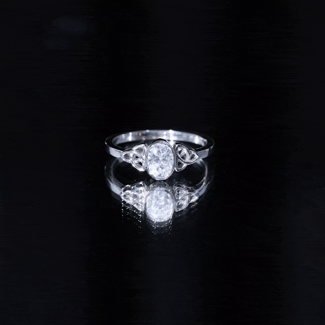 Yellow gold Celtic knot engagement ring with 5x7 mm oval lab-grown diamond, featuring intricate design and rose gold accents.