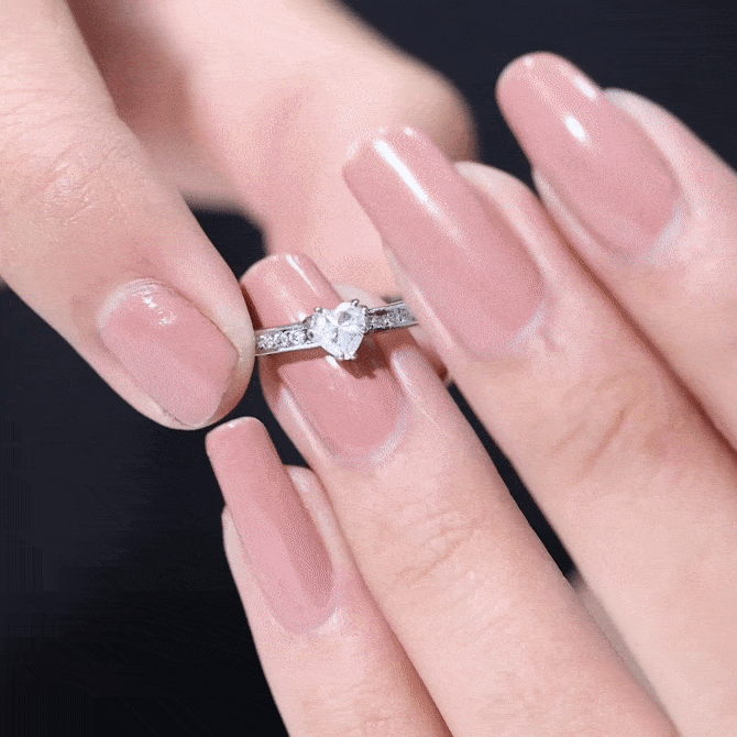 Lab grown diamond heart engagement ring with side stones in yellow gold, featuring a 5mm center diamond and intricate detailing.