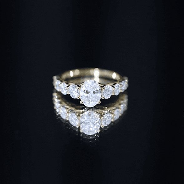 Lab grown 1.2 carat diamond oval engagement ring with side stones by Rosec Jewels, featuring a yellow gold band.
