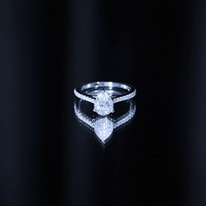 Yellow gold lab diamond pear-shaped engagement ring with side stones, featuring a 6x8 mm center diamond and intricate band design.