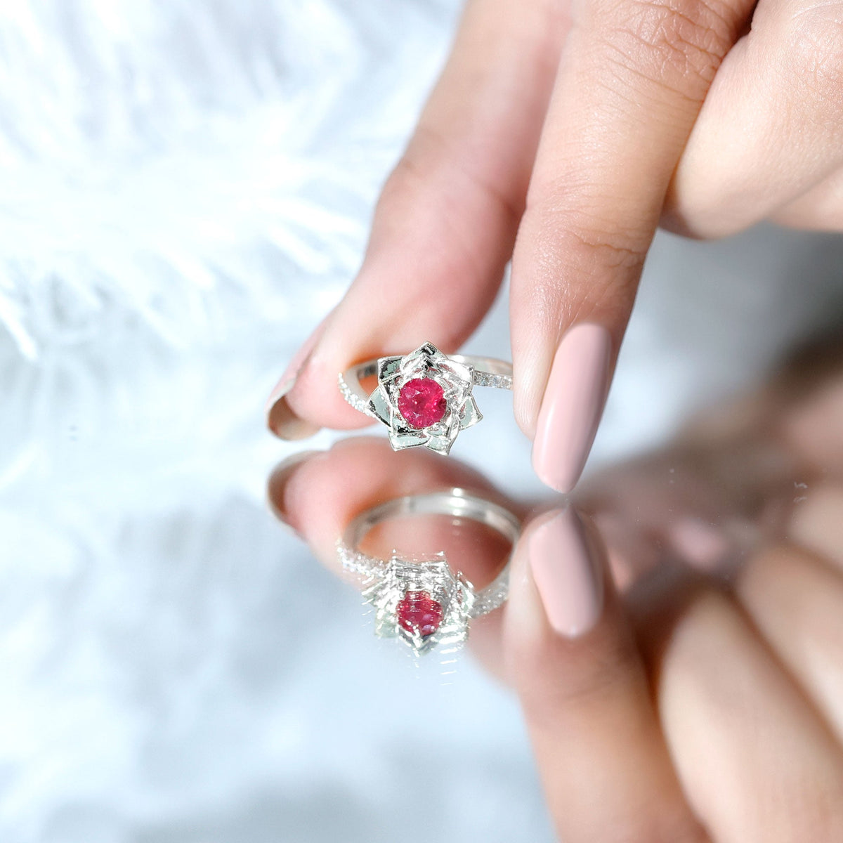 Natural 0.6 carat ruby flower engagement ring with diamond bypass shank by Rosec Jewels, showcasing a floral ruby centerpiece and delicate band.
