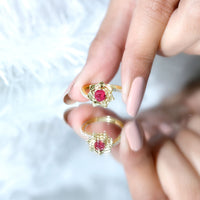 Natural 0.6 carat ruby flower engagement ring with diamond bypass shank from Rosec Jewels, showcasing intricate floral design and sparkling accents.