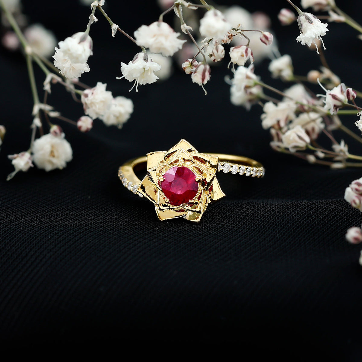 Natural 0.6 carat ruby flower engagement ring with diamond bypass shank, featuring intricate design and sparkling gemstones.