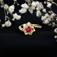 Natural 0.6 carat ruby flower engagement ring with diamond bypass shank, featuring intricate design and sparkling gemstones.