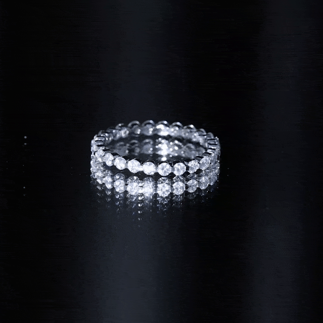 Yellow gold round cut moissanite full eternity band ring by Rosec Jewels with sparkling stones encircling the band.