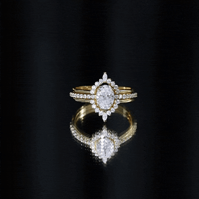 Yellow gold Moissanite oval engagement ring set with matching wedding bands by Rosec Jewels, featuring sparkling gemstones.